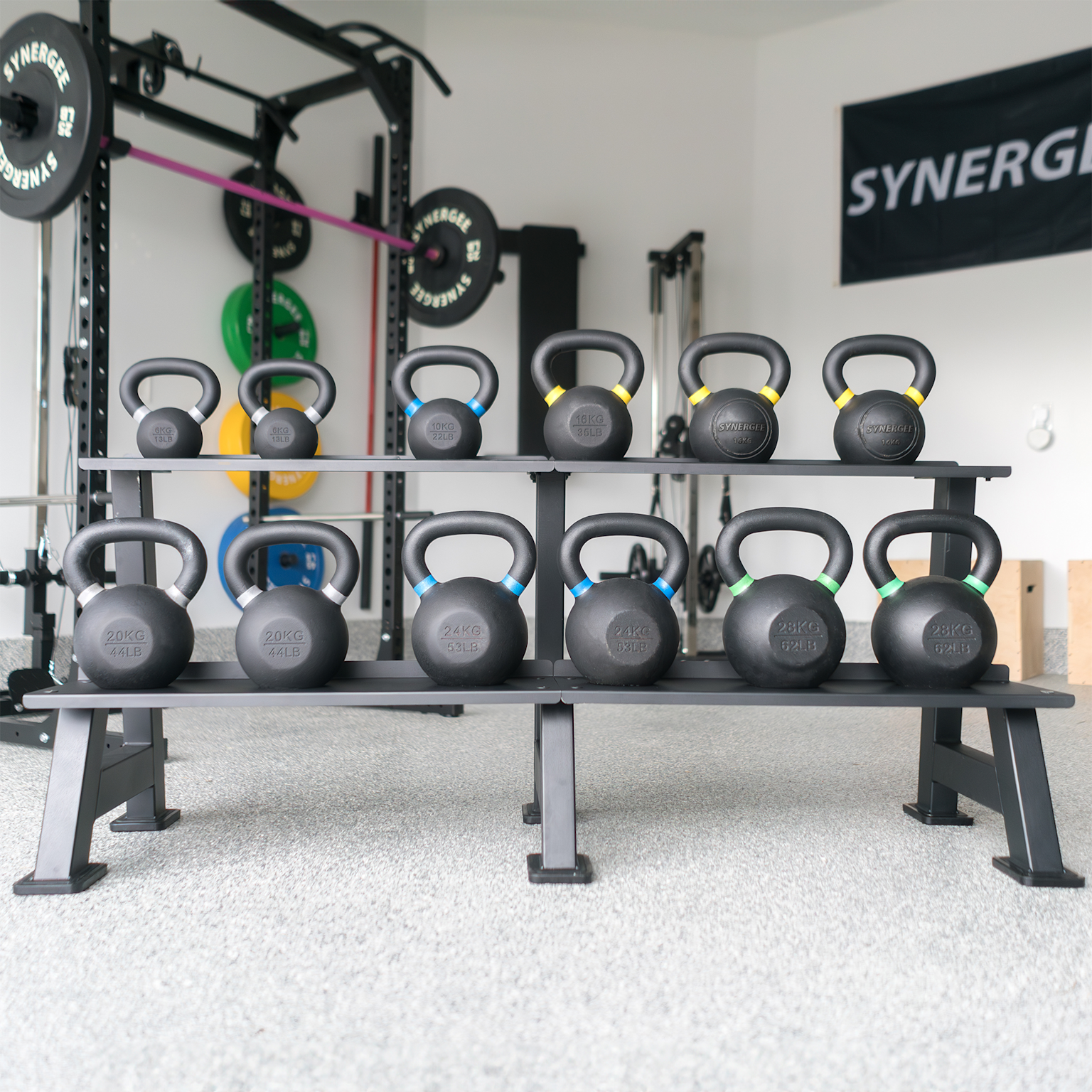 Organized home gym kettlebell rack with color-coded weights in a clean fitness room