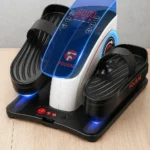 Compact motorized elliptical stepper with two black foot pedals, adjustable straps, and a central digital control panel showing 60:00, set on a wooden surface.